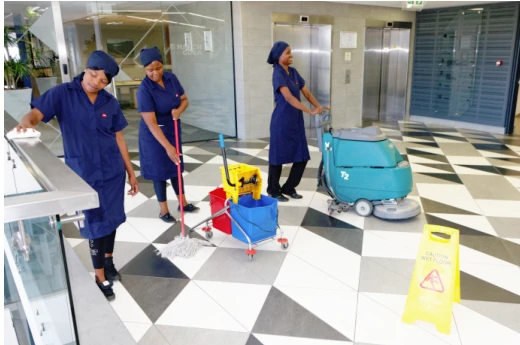 Blue Star cleaning team with a floor scrubber and cleaning equipment